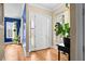 Inviting entryway with stylish hardwood floors, side-light windows, and a view of the dining room at 1188 Quick Rabbit Loop, Charleston, SC 29414