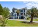 Charming blue two-story home with well-manicured lawn, stairs, and lush greenery offering curb appeal at 1188 Quick Rabbit Loop, Charleston, SC 29414