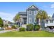 Charming two-story home with a well-manicured lawn and mature trees at 1188 Quick Rabbit Loop, Charleston, SC 29414