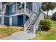 Home's exterior showcasing stairs leading to the entrance with a well-manicured lawn at 1188 Quick Rabbit Loop, Charleston, SC 29414
