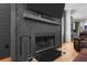 The fireplace is framed by a black accent wall for a modern design at 1188 Quick Rabbit Loop, Charleston, SC 29414