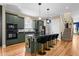 Beautiful kitchen featuring granite countertops, stainless steel appliances, island with chairs, and hardwood floors at 1188 Quick Rabbit Loop, Charleston, SC 29414