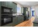 A functional kitchen featuring dark granite countertops and forest green cabinets at 1188 Quick Rabbit Loop, Charleston, SC 29414
