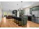 Open kitchen with stainless steel appliances, granite counters, large island, and view to the living room at 1188 Quick Rabbit Loop, Charleston, SC 29414