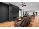 Cozy living room with a fireplace, ceiling fan, comfortable leather sofas, and hardwood floors at 1188 Quick Rabbit Loop, Charleston, SC 29414