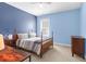 Cozy bedroom with blue walls, natural light, and a wood frame bed at 1243 Appling Dr, Mount Pleasant, SC 29464