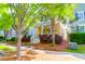 Charming yellow home with inviting front porch framed by lush greenery and mature trees at 1243 Appling Dr, Mount Pleasant, SC 29464