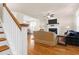 Cozy living room featuring hardwood floors, a fireplace, and open layout to dining area at 1243 Appling Dr, Mount Pleasant, SC 29464