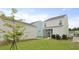 View of the backyard with a screened-in porch and detached garage at 131 Lilac Grove Way, Summerville, SC 29486