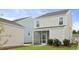 View of the backyard with a screened-in porch and detached garage at 131 Lilac Grove Way, Summerville, SC 29486