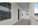 View of the balcony with sliding glass doors and white railings in this coastal style new home at 131 Lilac Grove Way, Summerville, SC 29486