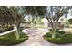 Inviting community gathering area with a circular seating area, surrounded by a brick walkway and landscaping at 131 Lilac Grove Way, Summerville, SC 29486