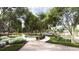 Lush landscaping surrounds the curving community path which leads to the pool area with umbrella-covered lounge chairs at 131 Lilac Grove Way, Summerville, SC 29486