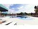 A resort-style pool with lounge chairs and umbrellas, with a pool house visible in the background at 131 Lilac Grove Way, Summerville, SC 29486