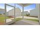 View from the screened-in porch looking at a detached one car garage and well maintained landscaping at 131 Lilac Grove Way, Summerville, SC 29486