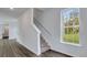 Staircase with view of the front yard through a double hung window at 131 Lilac Grove Way, Summerville, SC 29486