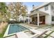 Beautiful backyard with a refreshing pool, outdoor seating under a covered patio, ideal for entertaining guests at 1412 Jackson St, Mount Pleasant, SC 29464