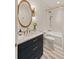 Stylish bathroom boasts a wood-trimmed mirror, marble countertop, and modern fixtures at 1412 Jackson St, Mount Pleasant, SC 29464