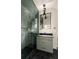 Updated bathroom features a glass shower door, modern fixtures and black tile flooring at 1412 Jackson St, Mount Pleasant, SC 29464