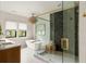Elegant bathroom featuring a soaking tub, walk-in shower with glass enclosure, and marble floors at 1412 Jackson St, Mount Pleasant, SC 29464