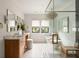 Bright bathroom featuring double vanity, large tub, and a glass enclosed shower at 1412 Jackson St, Mount Pleasant, SC 29464