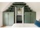 Green built-ins provide storage in ensuite bathroom with undermount sink and black fixtures at 1412 Jackson St, Mount Pleasant, SC 29464