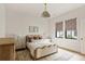 Bright bedroom featuring a cozy bed with neutral bedding and a unique overhead light fixture at 1412 Jackson St, Mount Pleasant, SC 29464