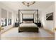 Spacious bedroom with a four-poster bed, bench, and modern lighting fixtures at 1412 Jackson St, Mount Pleasant, SC 29464