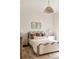 Bright bedroom featuring a cozy bed with neutral bedding and a unique overhead light fixture at 1412 Jackson St, Mount Pleasant, SC 29464