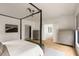 Spacious bedroom with a four-poster bed, bench, and entry to a bathroom at 1412 Jackson St, Mount Pleasant, SC 29464