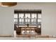 The dining room features a large window, a modern chandelier and hardwood floors at 1412 Jackson St, Mount Pleasant, SC 29464
