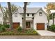 Beautiful two-story home with a metal roof, two-car garage, manicured front yard and inviting curb appeal at 1412 Jackson St, Mount Pleasant, SC 29464