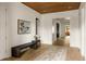 Foyer featuring hardwood floors, a wooden ceiling, statement artwork, and a bench for comfortable entry at 1412 Jackson St, Mount Pleasant, SC 29464