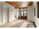 Bright foyer with wood ceiling, staircase, and double front doors leading to outdoor views, with stylish decor at 1412 Jackson St, Mount Pleasant, SC 29464