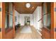 Grand foyer entrance featuring light hardwood floors, wooden ceiling and double wood doors with a view to the front porch at 1412 Jackson St, Mount Pleasant, SC 29464
