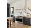 This is a modern kitchen with a marble backsplash, stainless steel appliances, dark cabinets, and hardwood flooring at 1412 Jackson St, Mount Pleasant, SC 29464