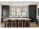 Spacious kitchen with dark cabinets, marble countertops, a large island, and natural light from multiple windows at 1412 Jackson St, Mount Pleasant, SC 29464