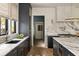 Stylish kitchen with dark cabinets, marble countertops and backsplash, and high-end appliances for cooking at 1412 Jackson St, Mount Pleasant, SC 29464
