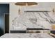 This is a close-up of a gourmet kitchen featuring marble backsplash, stainless steel appliances and brass accents at 1412 Jackson St, Mount Pleasant, SC 29464