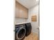 Chic laundry room with side-by-side washer/dryer, gray cabinetry, and marble countertops at 1412 Jackson St, Mount Pleasant, SC 29464