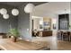 Open-concept living area showcases hardwood floors, a smooth stone wall, and seamless access to the kitchen at 1412 Jackson St, Mount Pleasant, SC 29464