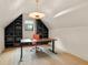Home office with custom built-in bookcase, modern desk, and unique light fixture at 1412 Jackson St, Mount Pleasant, SC 29464