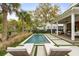 An inviting backyard pool, complemented by comfortable loungers and lush landscaping, perfect for outdoor enjoyment at 1412 Jackson St, Mount Pleasant, SC 29464
