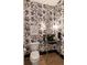 This is a stylish powder room with floral wallpaper, a unique vanity and a round mirror at 1412 Jackson St, Mount Pleasant, SC 29464