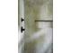 Close-up on a shower with elegant green tile, black fixtures, and recessed niche at 1412 Jackson St, Mount Pleasant, SC 29464