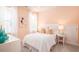 Cozy bedroom with a white bed, soft lighting, and light peach colored walls at 1431 Clay Field Trl, Summerville, SC 29485