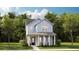 Charming two-story home with light blue siding, covered front porch, and well-manicured lawn at 1431 Clay Field Trl, Summerville, SC 29485
