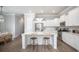 Bright, modern kitchen with white cabinets, stainless steel appliances, and a large center island with seating at 1431 Clay Field Trl, Summerville, SC 29485
