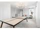 Versatile bonus room featuring a ping pong table, comfortable seating, and ample natural light at 1433 Clay Field Trl, Summerville, SC 29485