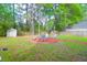 Backyard firepit surrounded by an ample seating area and mature landscaping at 144 Jupiter Ln, Summerville, SC 29483